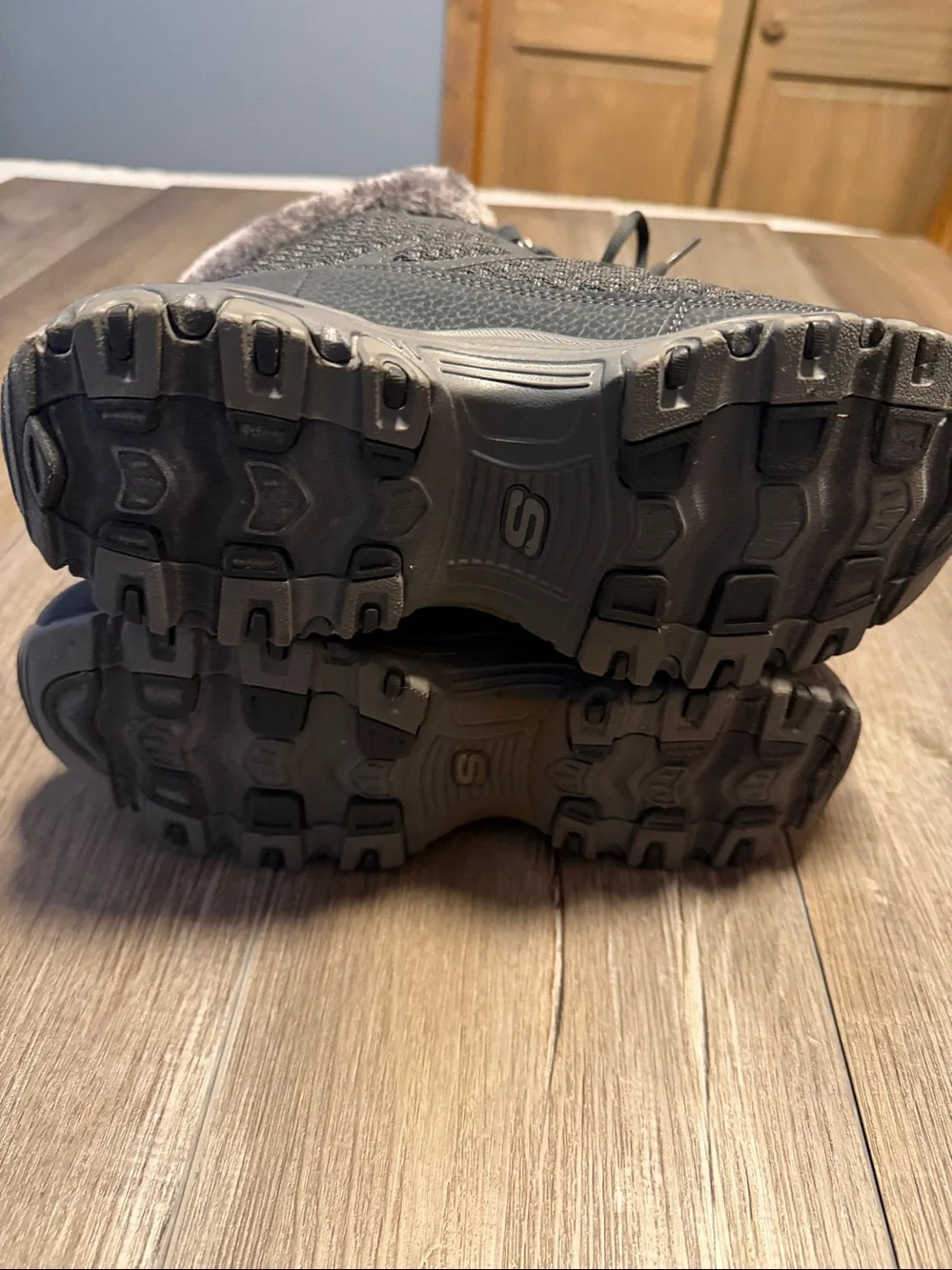 Skechers D'Lites Bomb Cyclone winter boots in a charcoal color, featuring a faux